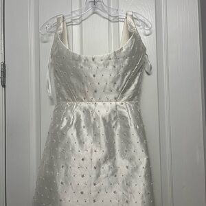 Beautiful white dress with embellishments on it. Such a cute cocktail dress.
